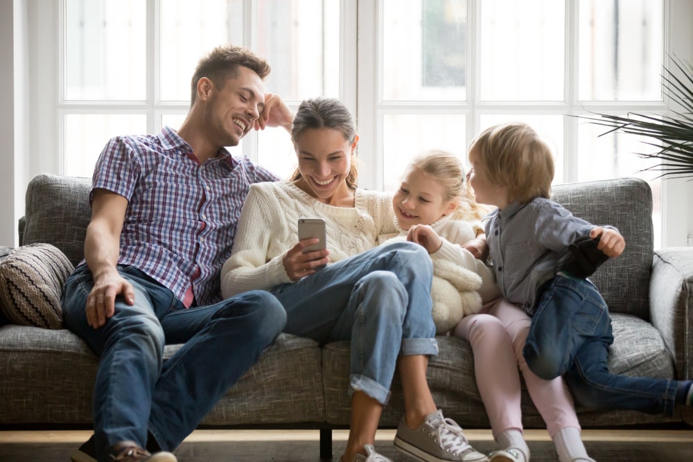 family gathered around phone - are they watching ads?